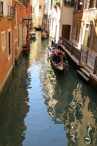 Gondola ride through a narrow canal in Venice, Italy