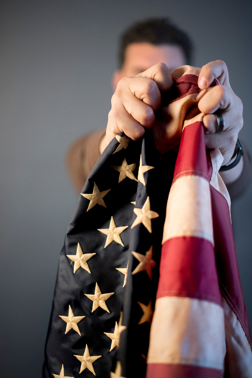 Man Holding American Flag Close Up