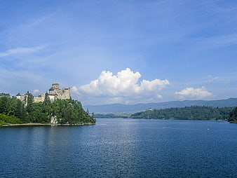 Orava Castle on a hill overlooking a blue lake in Slovakia