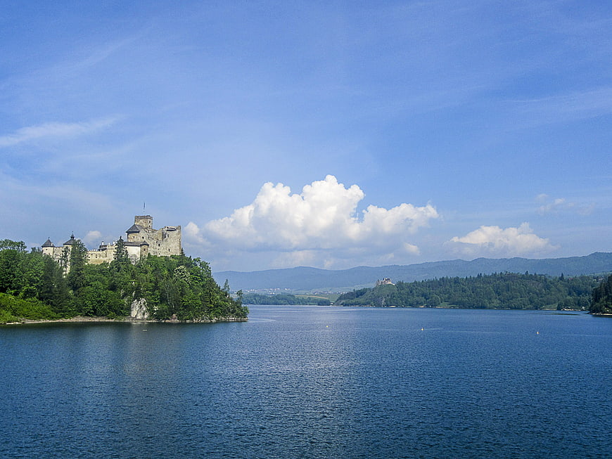 Orava Castle on a hill overlooking a blue lake in Slovakia