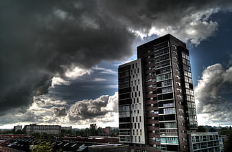 Modern Apartment Building Under Dramatic Stormy Sky
