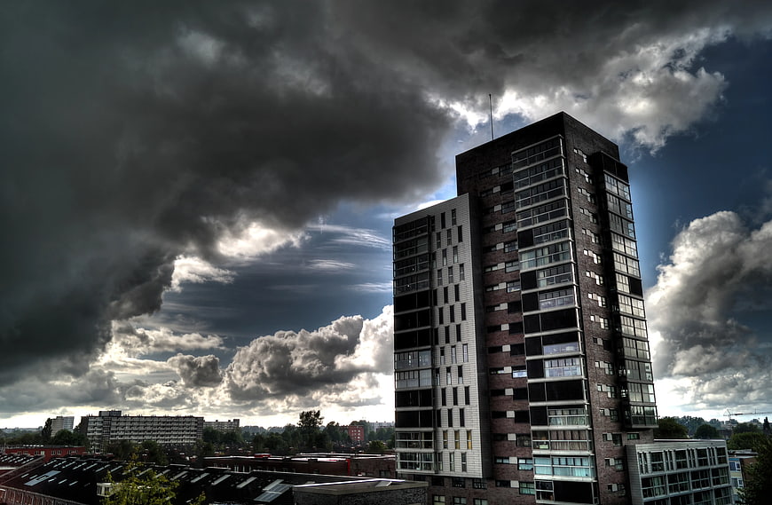 Modern Apartment Building Under Dramatic Stormy Sky