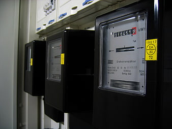 Close-up of industrial electricity meters on a wall