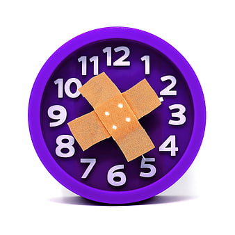 Purple alarm clock with adhesive bandage on face