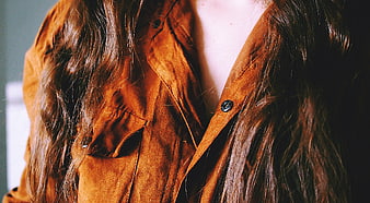 Close-up of woman in brown suede jacket with long hair