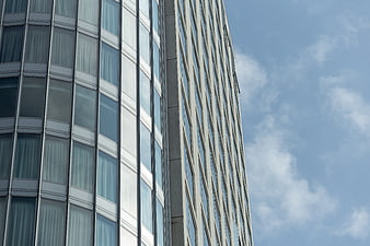 Modern Glass Office Building Exterior with Blue Sky