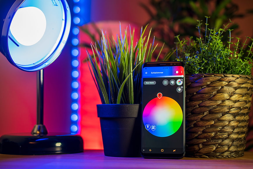 Smartphone controlling smart home lighting with colorful interface