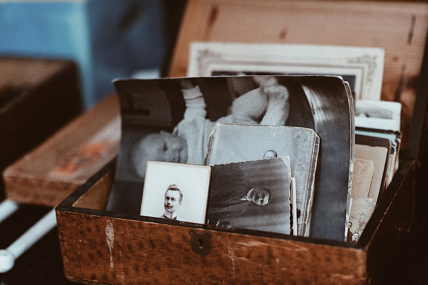 Vintage black and white photographs in an old wooden box