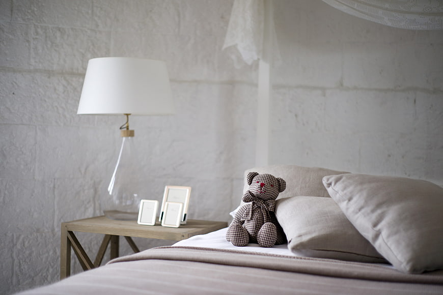 Cozy Bedroom Interior with Teddy Bear and Lamp