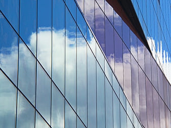 Modern Glass Building Facade with Sky Reflection