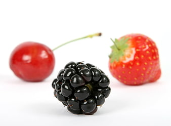 Fresh blackberry, cherry, and strawberry on white background