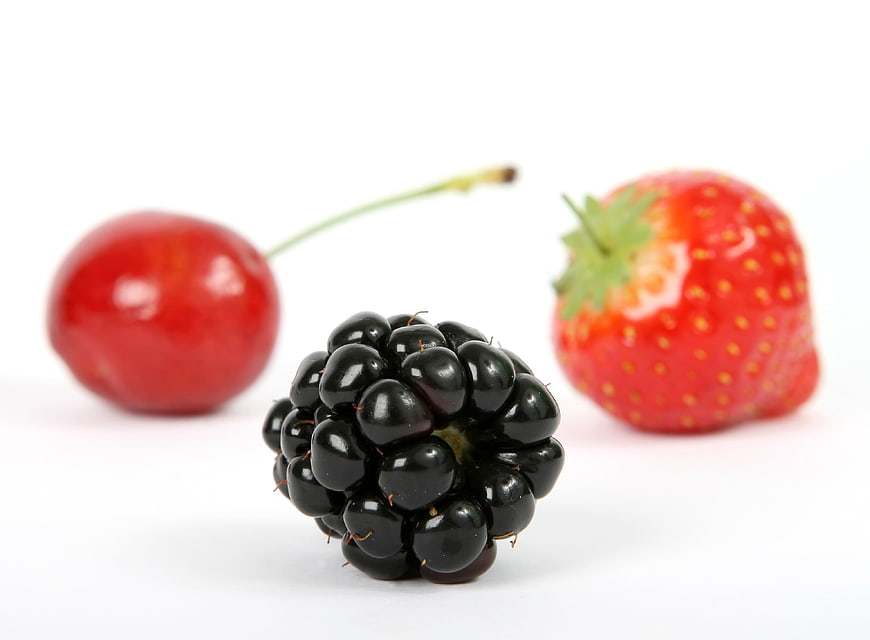 Fresh blackberry, cherry, and strawberry on white background