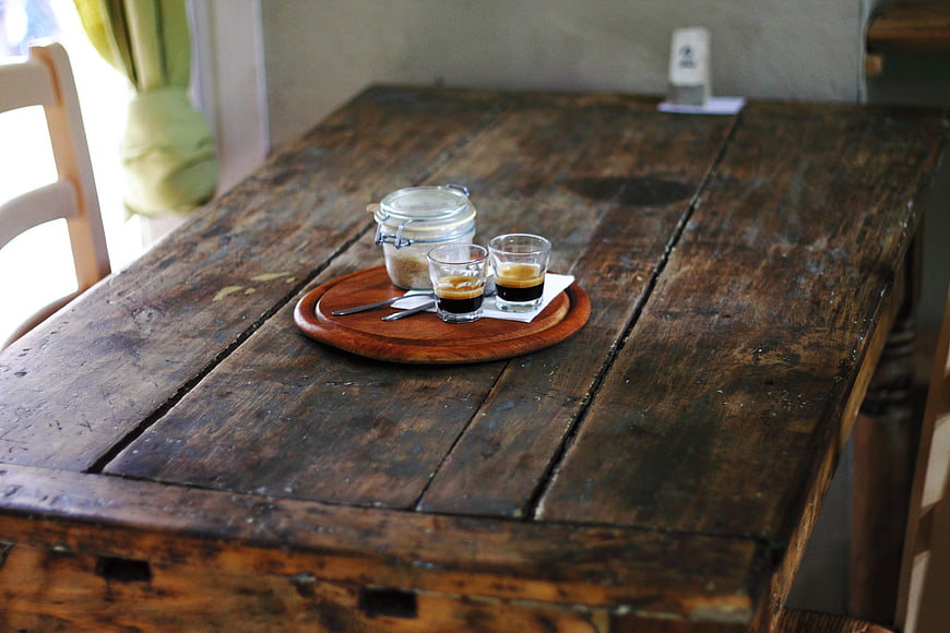 Rustic wooden table with espresso and sugar jar
