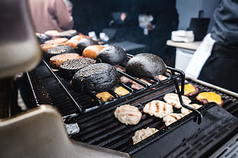 Grilling black squid ink burger buns and chicken patties
