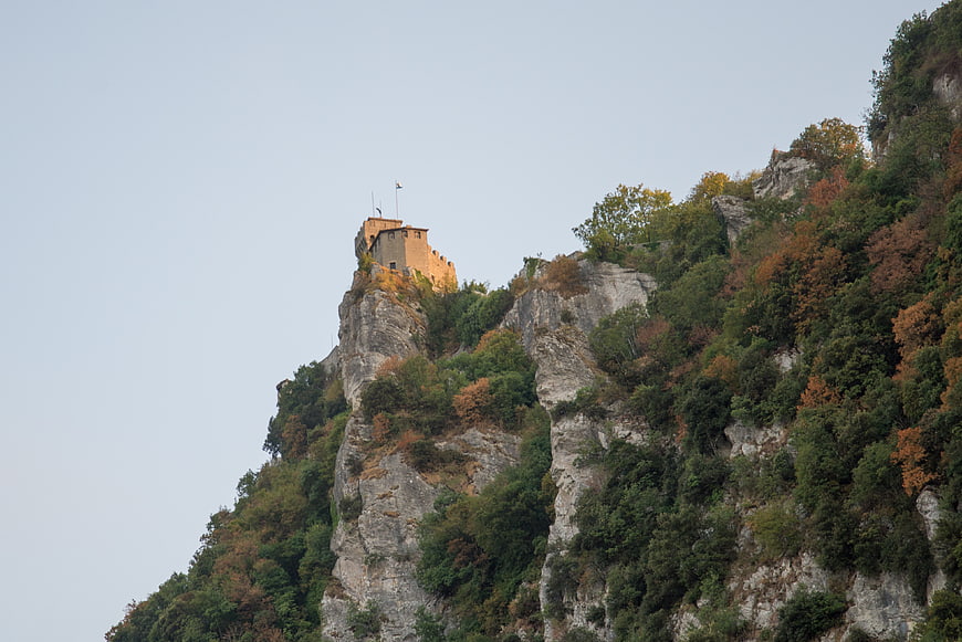 Medieval fortress perched on a rocky mountain peak in autumn