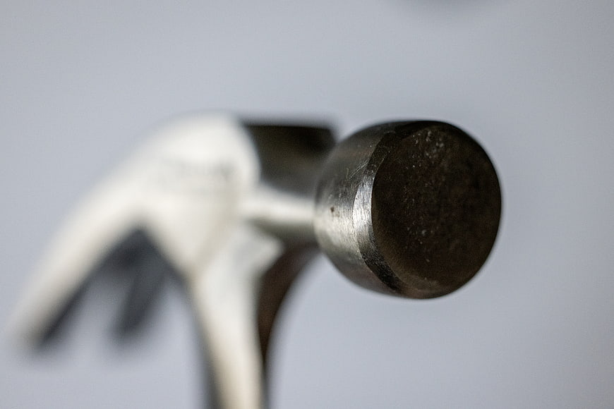 Close-up of metal hammer head on gray background