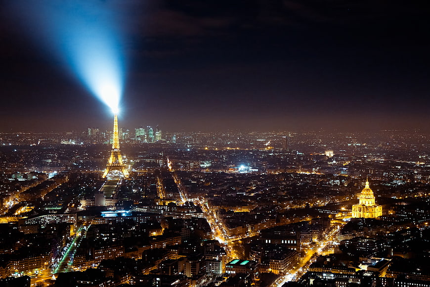 Aerial Night View of Paris Cityscape with Eiffel Tower Searchlight