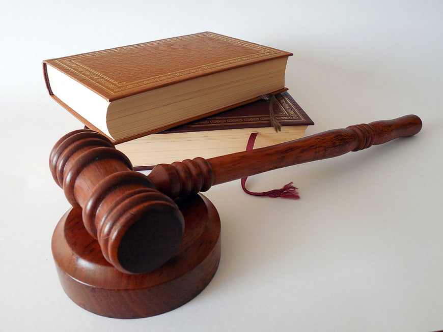 Wooden Judge Gavel and Law Books on White Background