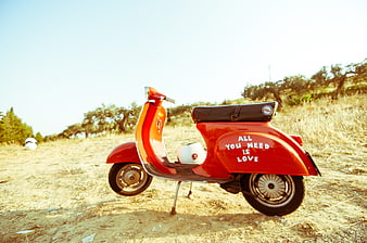 Vintage Red Scooter with All You Need Is Love Text