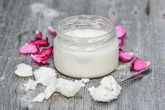 Natural Coconut Oil in Glass Jar with Rose Petals