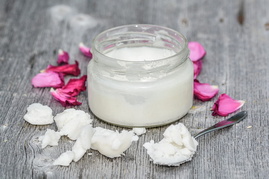 Natural Coconut Oil in Glass Jar with Rose Petals