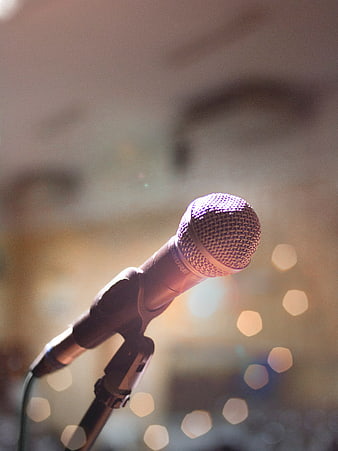 Close-up of microphone on stand with bokeh lights