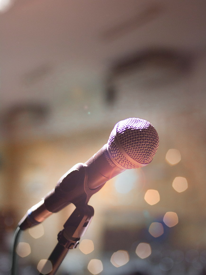 Close-up of microphone on stand with bokeh lights