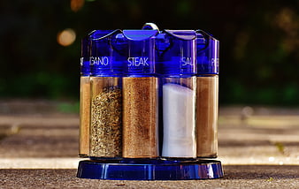 Blue rotating spice rack with labeled seasoning jars