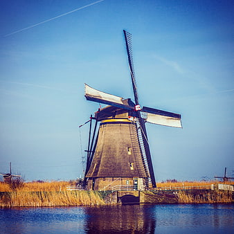Traditional Dutch Windmill by Canal in Autumn
