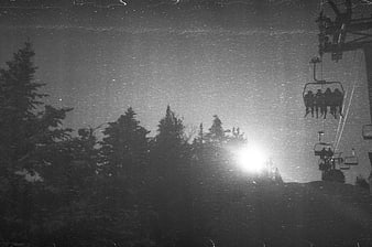 Black and white night skiing with chairlift and snow