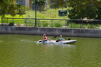 Father and Son Kayaking on a Green River