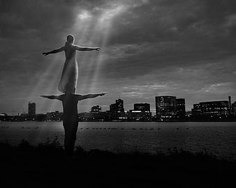 Acro Yoga Couple Silhouette Against Dramatic City Skyline