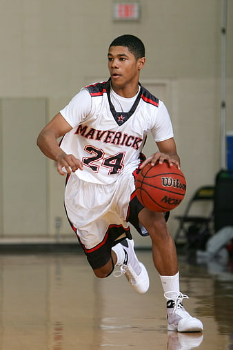 Young Basketball Player Dribbling on Indoor Court