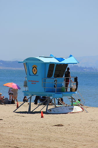 Blue Lifeguard Tower On Sunny Beach With Ocean View