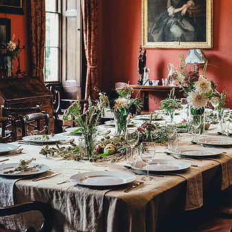 Rustic Formal Table Setting With Floral Arrangements In Historic Dining Room