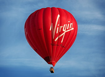 Red Virgin Hot Air Balloon Flying in Blue Sky