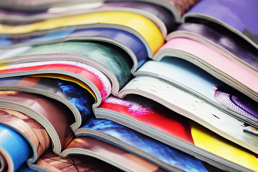 Close-up of colorful magazine pages fanned out