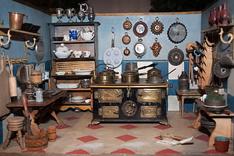 Antique dollhouse kitchen with vintage stove and utensils