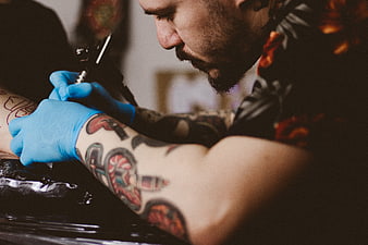 Tattoo Artist Working on Client's Arm