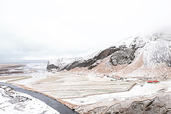 Snowy Mountain Landscape with River and Village in Winter