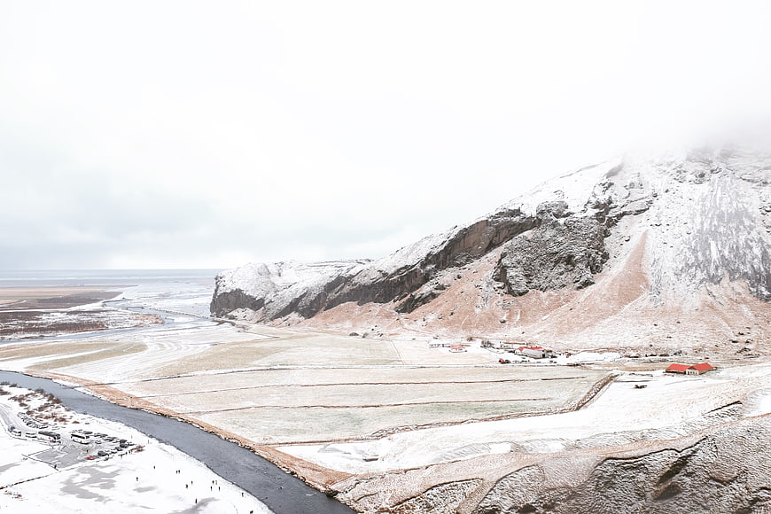 Snowy Mountain Landscape with River and Village in Winter