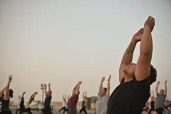 Outdoor Yoga Class at Sunset with Raised Arms