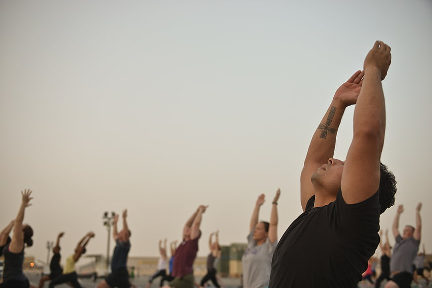 Outdoor Yoga Class at Sunset with Raised Arms
