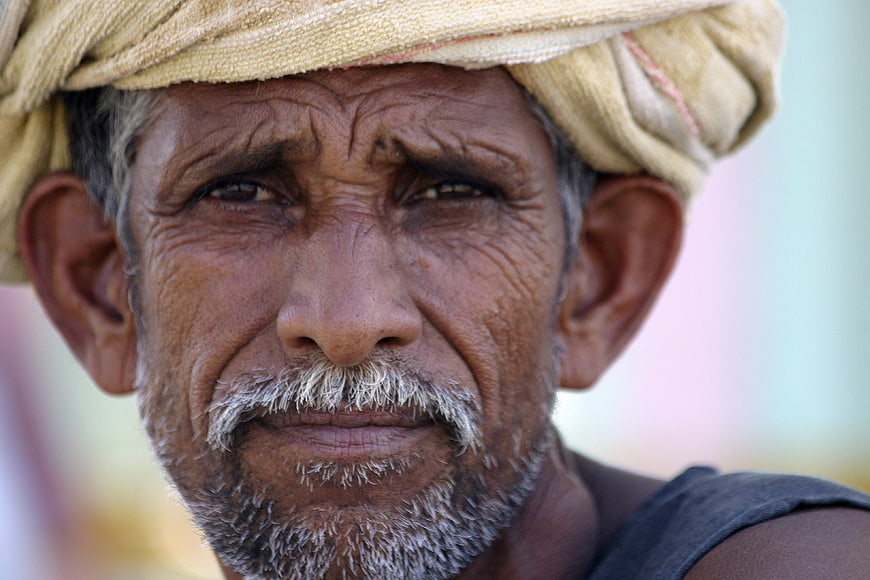 Close-up portrait of an elderly Indian man with a turban