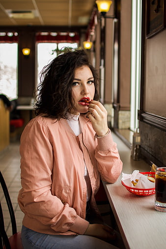 Woman Eating Fries in a Casual Restaurant
