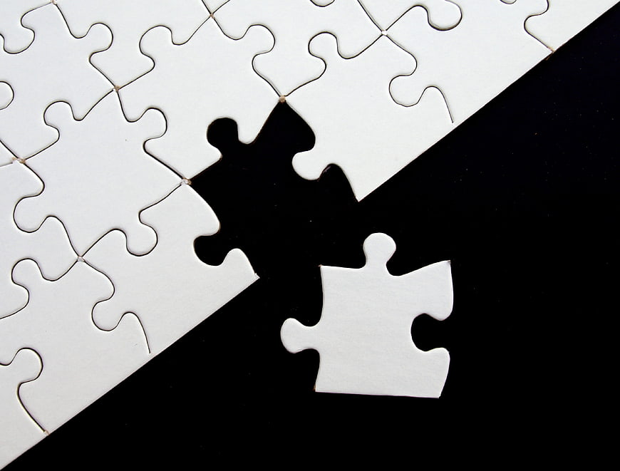 Missing white puzzle piece on black background