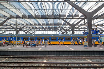 Blue and yellow train at Rotterdam Central Station platform