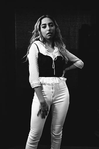 Black and white portrait of stylish young woman posing