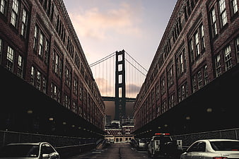 Golden Gate Bridge framed by brick buildings in San Francisco