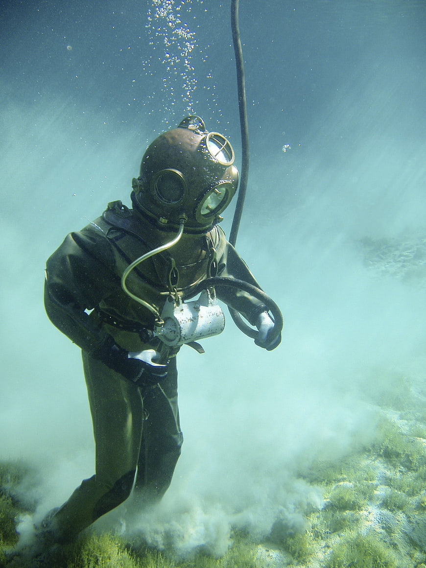 Vintage deep sea diver underwater with bubbles